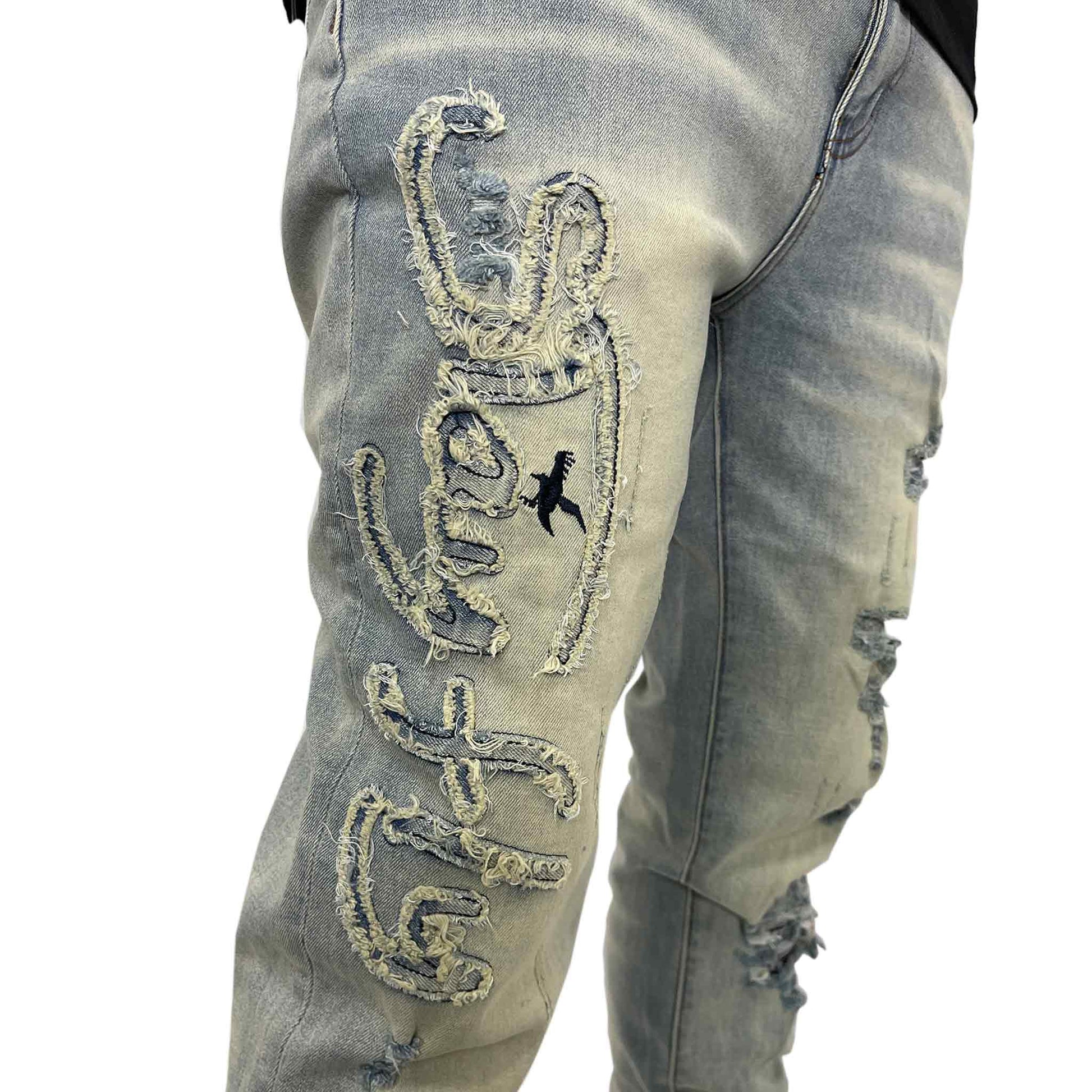 Close up of designed Stay Fly words sewn into right leg of Jean